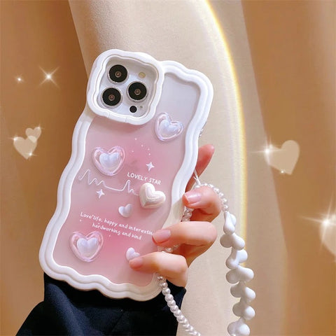 Person holding a Heart Strings phone case with colorful hearts design