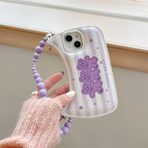 A person holding a purple phone case with a purple bead on it - stylish and convenient phone case holder with shoulder strap